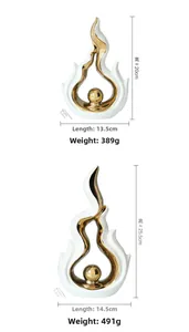 Detailed size specifications for two modern abstract ceramic sculptures in white and gold