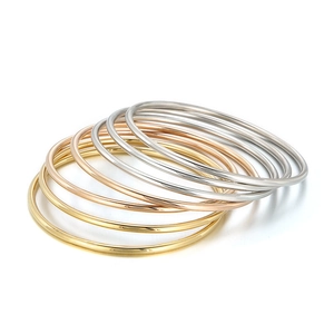 Set of seven 3mm stackable round bangles in gold silver and rose gold polished titanium steel