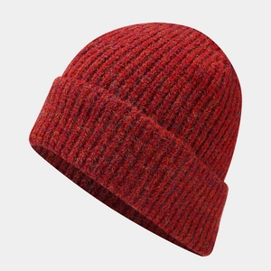 Detailed texture of thick maroon knit beanie with cuffed edge and chunky ribbed pattern