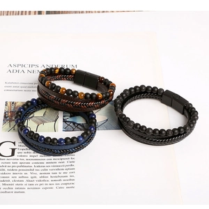 Detail view of woven leather bracelets with natural tiger eye and lapis lazuli stones