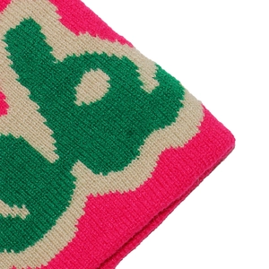 Detail of ribbed knit texture with vibrant pink, green, and cream jacquard patterns