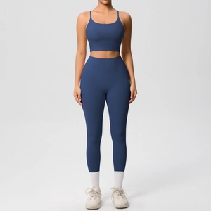 Detail of navy blue high-waist yoga leggings and strap sports bra set in matte finish