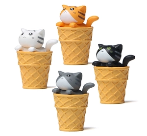 Close-up of four colorful miniature cats sitting in waffle cones for garden decor