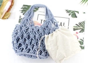 Detail of blue hand-woven cotton net bag with beige drawstring inner pouch on table