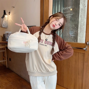 Plush white fleece cosmetic bag shown with model in a cozy lifestyle setting
