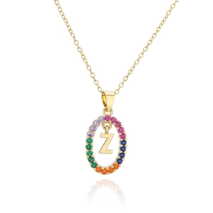 Macro detail of gold-plated necklace featuring a Z pendant with rainbow zircon stones