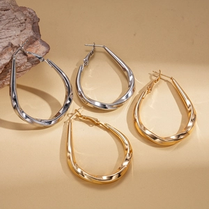 Minimalist twisted teardrop geometric earrings in polished gold and silver finish