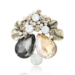 Vintage crystal flower brooch with champagne rhinestones on a white background