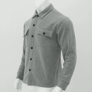 Detail of grey men's slim-fit jacket showing textured fabric and dual chest pockets