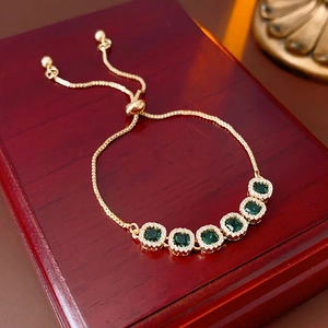 Adjustable gold bracelet with square green zircon stones and white diamond accents