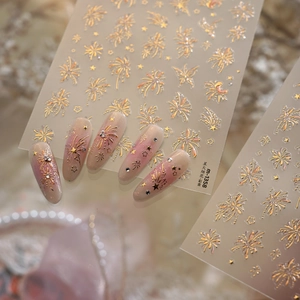Detailed macro of M1358 gold foil firework nail stickers with elegant gradient finish