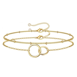Detail of gold double-layer chain bracelet featuring interlocking rings and beads