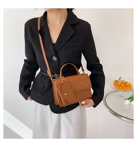 Quilted caramel handbag with matching mini pouch and elegant gold hardware details