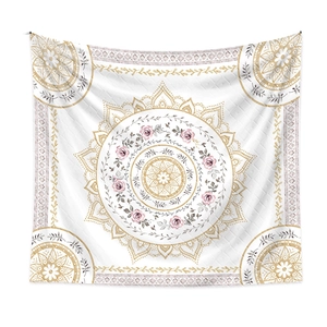 Detail of bohemian mandala tapestry featuring pink roses and golden patterns on fabric