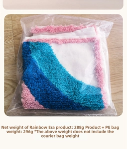 Macro detail of tufted geometric fabric cushion with pink fringe in transparent packaging