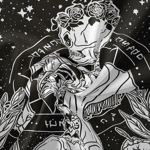 Close-up of black bohemian tapestry featuring a skull with roses and mystic star patterns
