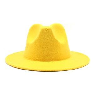 Detail view of bright yellow wool felt fedora with a wide brim and classic crown design