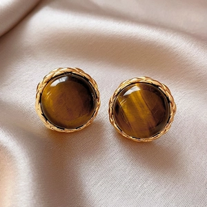 Vintage 14K gold plated earrings with brown tiger eye stone on silk background