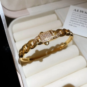 Detail view of gold-plated bangle with micro-pave zircon rectangular buckle clasp