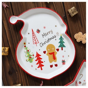 Ceramic Santa hat dinner plate with Merry Christmas lettering on dark wood background