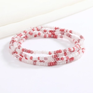 Close-up of handmade multi-layer beaded waist chain in pink and white glass beads