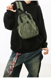 Detail of army green nylon crossbody bag with drawstring design for outdoor use