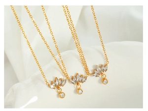 Detailed macro view of 18K gold plated lotus petal necklaces with sparkling zircons