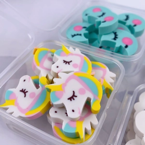 Detailed close-up of cute cartoon unicorn and blue moon shaped erasers in a clear box