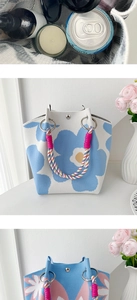 Detailed knit tote bag showing floral patterns and woven rope handles with spacious interior