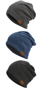 Close-up of thick waffle knit texture on winter beanies with brown leather thinking pi label