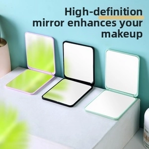 Detail of portable folding vanity mirrors in purple, black and mint green finishes