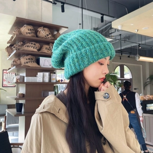 Thick turquoise knit beanie with a rolled edge, oversized cozy style for winter warmth
