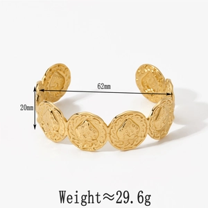 Detail of gold-plated stainless steel cuff bracelet with strawberry motif and wavy edges