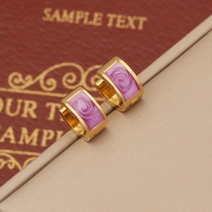 Elegant gold plated hoop earrings with purple enamel floral relief pattern and metal texture