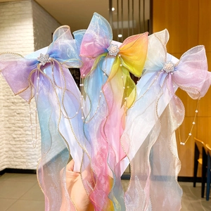 Rainbow bow hair clips for girls with sparkling star charms and long pearl tassels