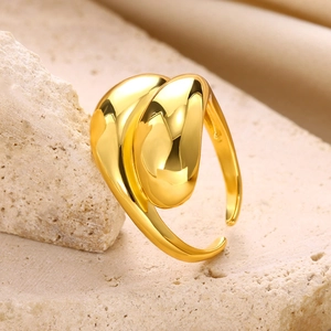 Macro shot of gold teardrop knot ring with high-polish finish on natural stone