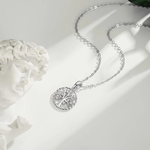 S925 sterling silver tree of life necklace with zircons on a white artistic background