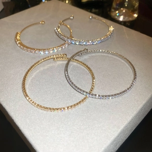 Macro shot of 4-piece gold and silver bangle set with micro-pave cubic zirconia crystals