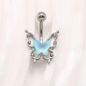 Detailed macro of a light blue acrylic butterfly belly ring with silver curved barbell