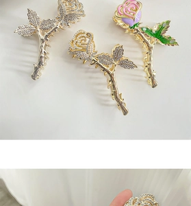 Detail of metal rose claw clips with gold plating, rhinestones and colorful enamel