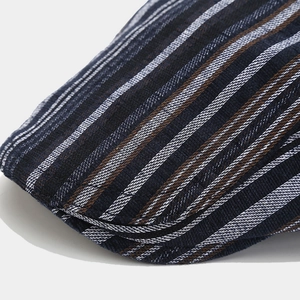 Detailed macro shot of high-density knit fabric texture on plaid newsboy flat cap