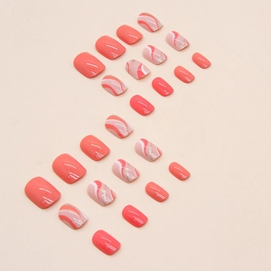 Glossy coral pink and orange wavy short press-on nails set with gold glitter accents