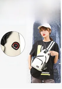 Detail of white nylon crossbody chest bag featuring a functional headphone jack and zip pocket