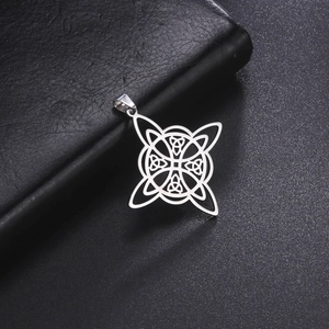 Close-up of silver stainless steel Celtic knot pendant on dark leather surface