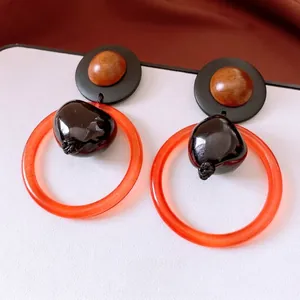 Retro resin and wood bead hollow circle drop earrings with orange acrylic accent