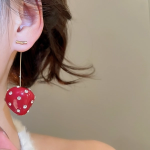 Close-up of model wearing red resin strawberry drop earrings with sparkling rhinestones