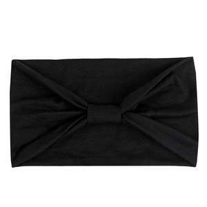 Close-up of black elastic sweatband with center knot design and soft fabric texture
