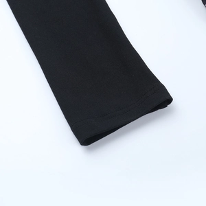 Close-up of knit fabric sleeves with double-needle stitching on a black A-line dress