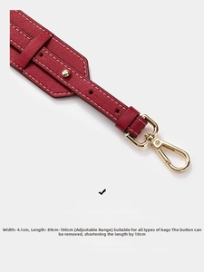 Detail of red pebbled leather strap with gold buckle and adjustable 4.1cm width