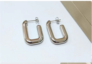 Minimalist chunky silver rectangular U-shaped hoop earrings detail view, modern design.